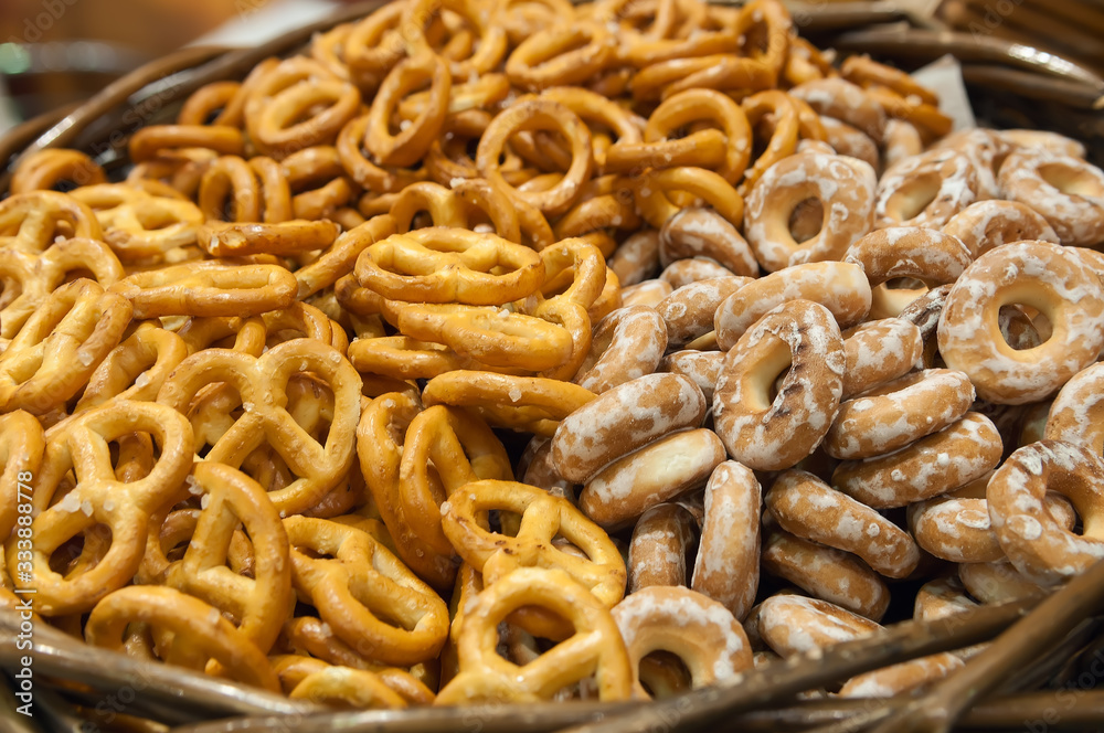 Salty pretzels close-up in wicker basket, top view. Oktoberfest mini pretzel, beer snack. Salty pretzels close-up in wicker basket, top view. Oktoberfest mini pretzel, beer snack.