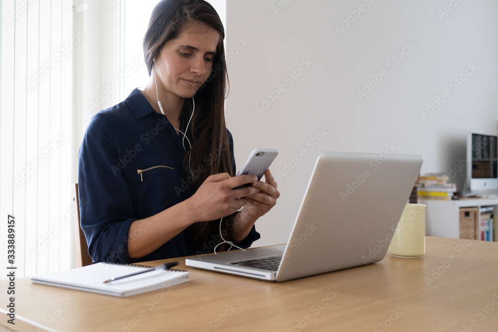 Smart working, young woman working from home on her laptop computer Smart working, young woman working from home on her laptop computer