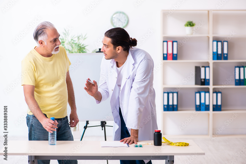 Fototapeta premium Doctor dietician giving advices to fat overweight patient