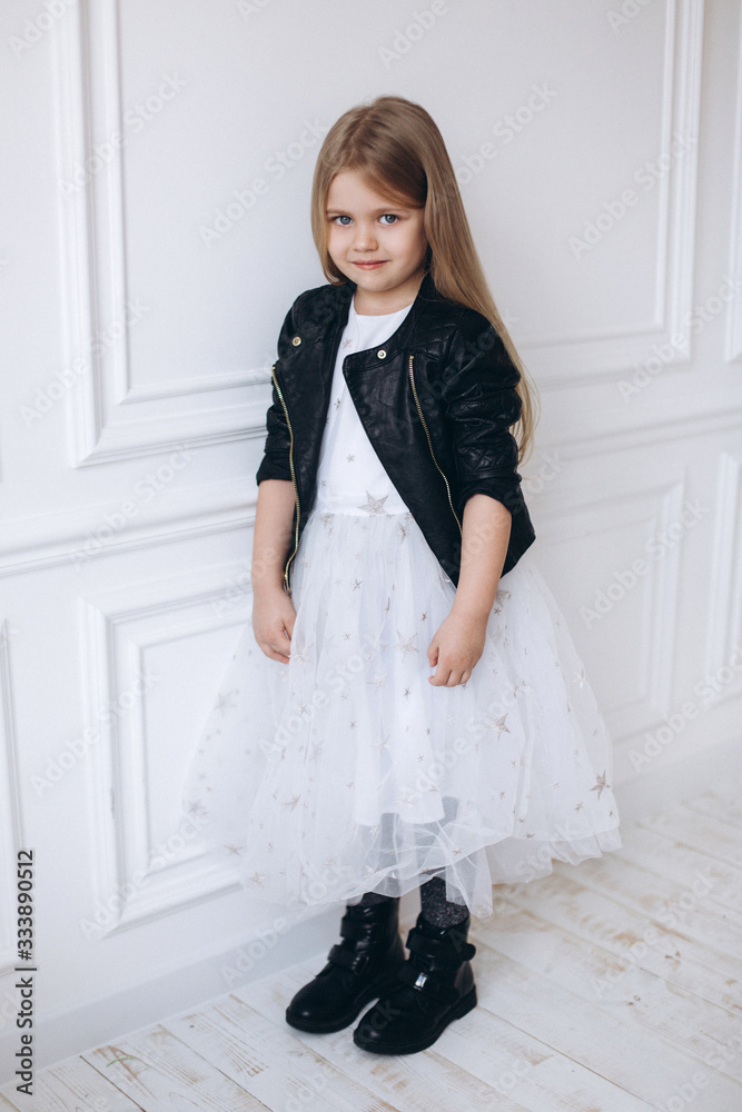 Portrait of cute adorable blondie little girl smiling and posing in studio. Fashion kids, childhood, happiness concept Portrait of cute adorable blondie little girl smiling and posing in studio. Fashion kids, childhood, happiness concept