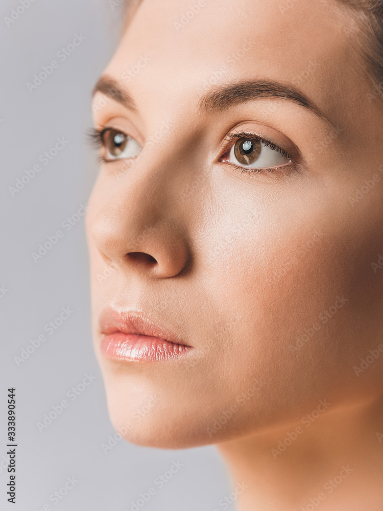 Close-up of an attractive girl with fair skin and brown eyes. Retouched skin, studio shot Close-up of an attractive girl with fair skin and brown eyes. Retouched skin, studio shot