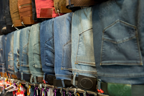 A lot of different blue jeans in the shop. Denim clothes store © Wedding photography