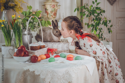 little girl with rabbit  in the kitchen,  Easter holiday