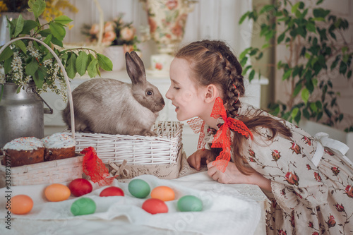 little girl with rabbit  in the kitchen,  Easter holiday