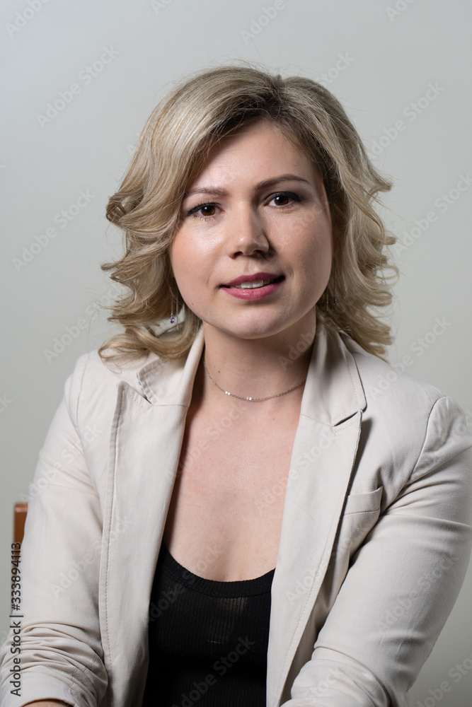 woman with blond hair posing on a white background