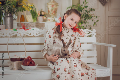 little girl with rabbit  in the kitchen,  Easter holiday