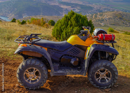 Two atv quad motorbikes standing on the top of mountain. sunny weather. leisure tourism hobby concept. outdoor adventures