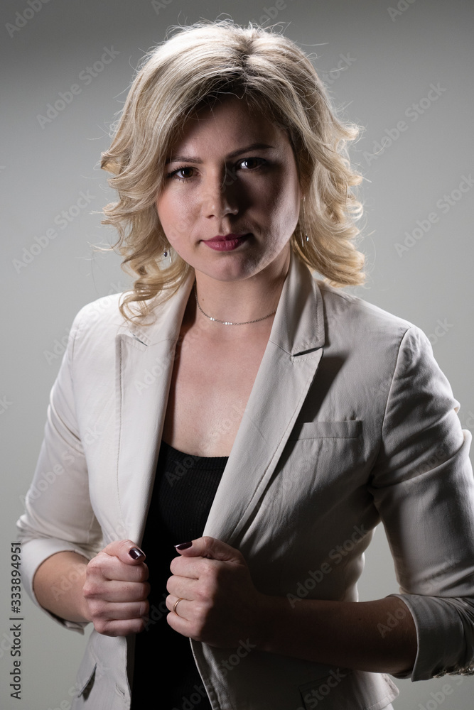 30 years old woman with blond hair in business clothes posing