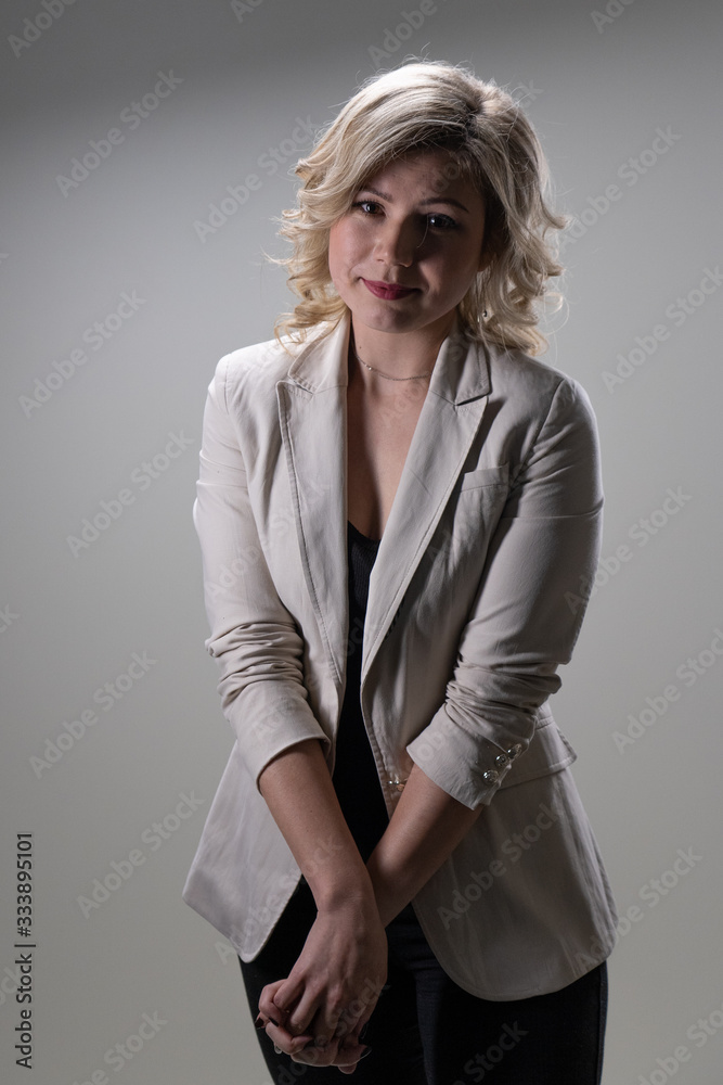 30 years old woman with blond hair in business clothes posing