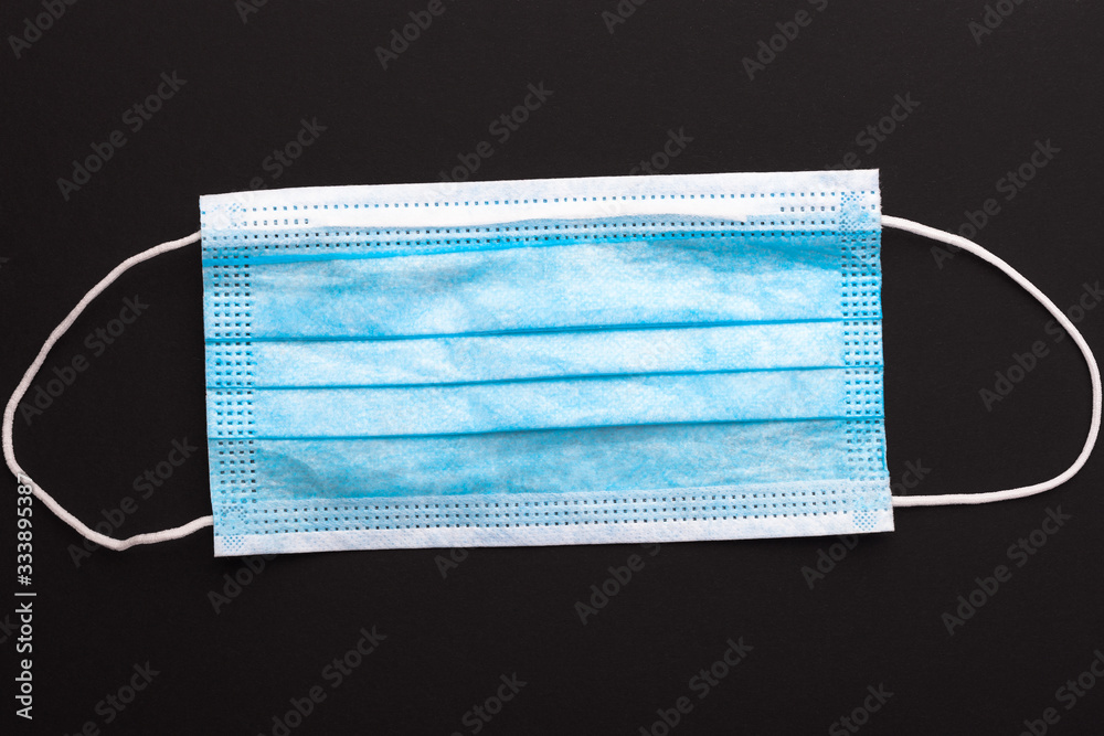 Medical mask on a black background, close-up, protection concept. Medical mask on a black background, close-up, protection concept.