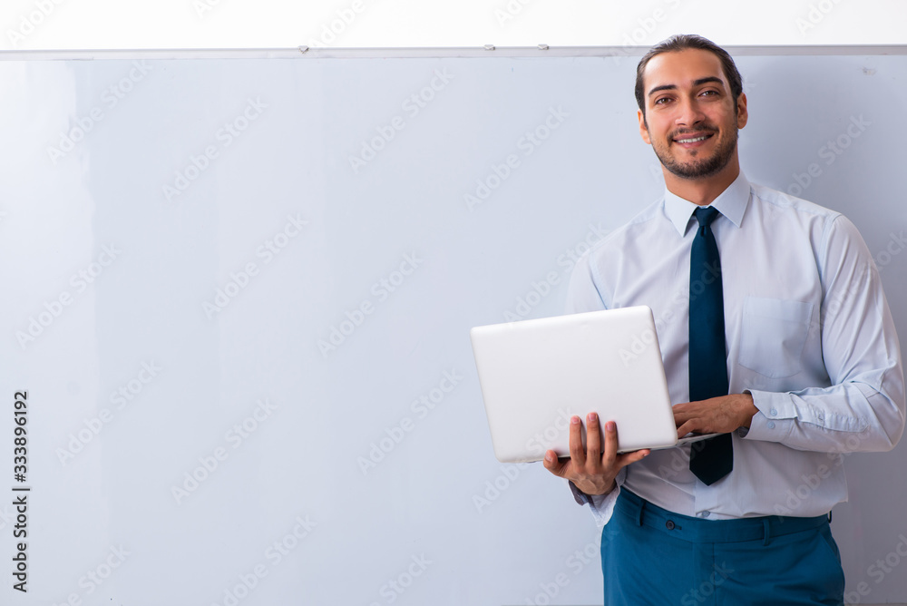 Young male employee in business presentation concept Young male employee in business presentation concept