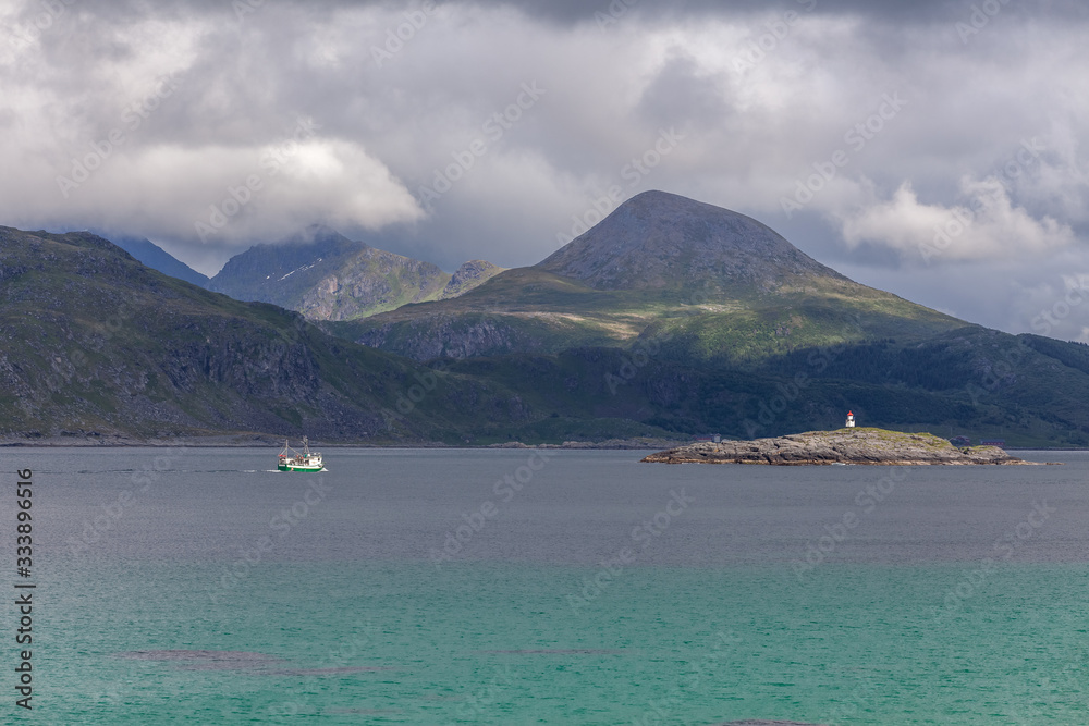 Beautiful view of the Norwegian fjords with turquoise water surrounded by cloudy sky, selective focus Beautiful view of the Norwegian fjords with turquoise water surrounded by cloudy sky, selective focus