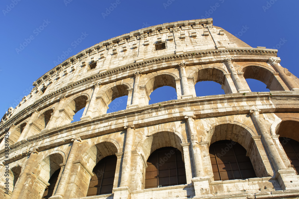 Part of Colosseum at blue sky in Rome, Italy, Europe.
