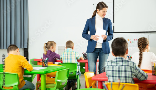 Teacher controlling learning process in primary school © JackF