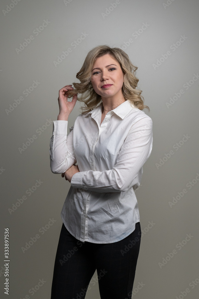 30 years old woman with blond hair in a white shirt posing