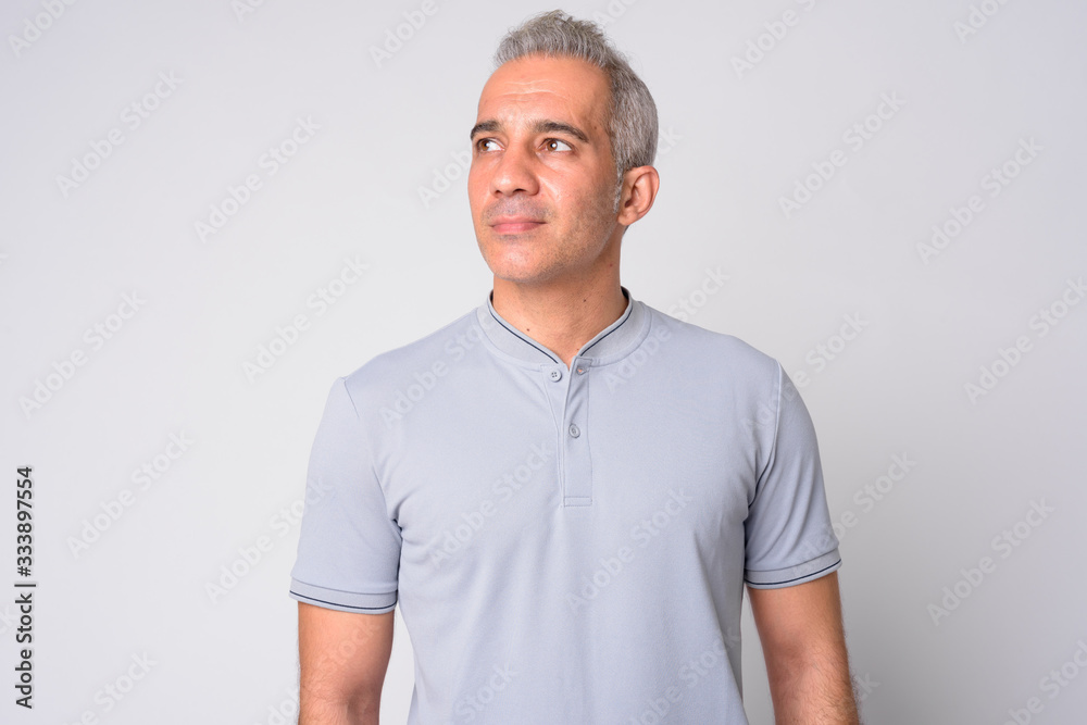 Portrait of handsome Persian man thinking and looking up Portrait of handsome Persian man thinking and looking up