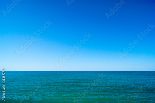 Calm sea and blue sky, horizontal photo.