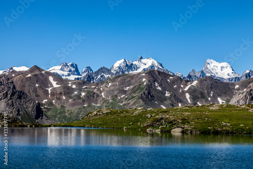 View of the Ecrins Massif with Barre des   crins  4102m  and Mont Pelvoux  3932m  from Snake Lake  248m  located on Claree Valley in Nevache  Hautes Alpes  France
