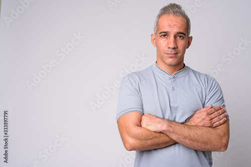 Portrait of handsome Persian man with arms crossed