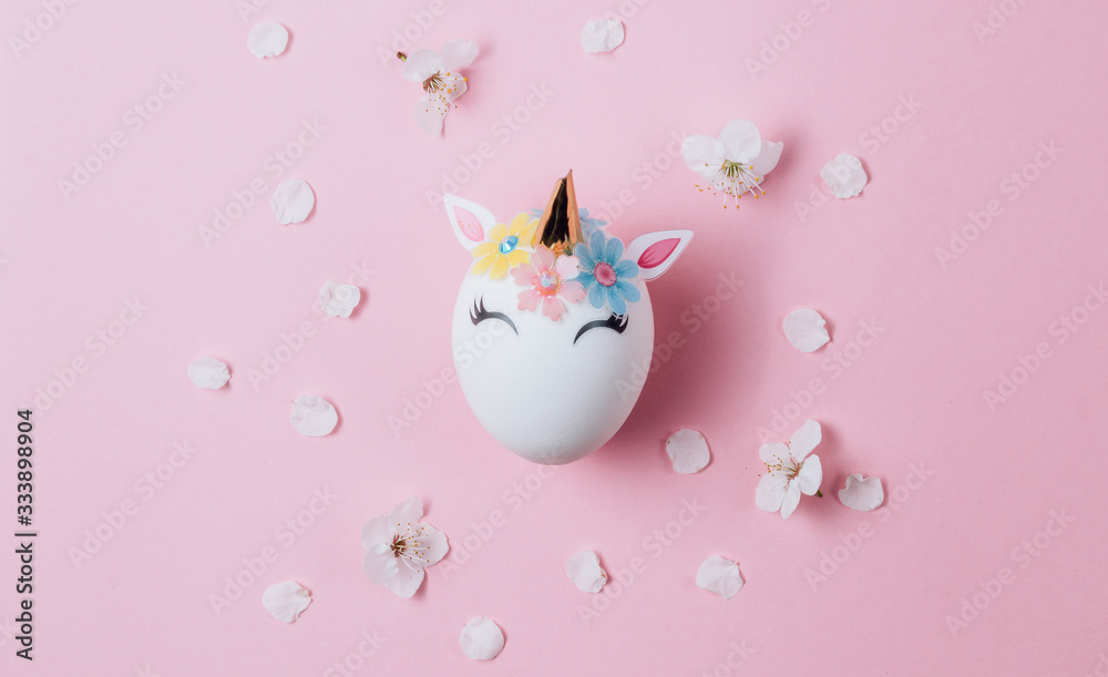 Easter eggs in the form of a unicorn on pink background. Happy Easter time. Creative Easter decoration. Copy space. Flat lay