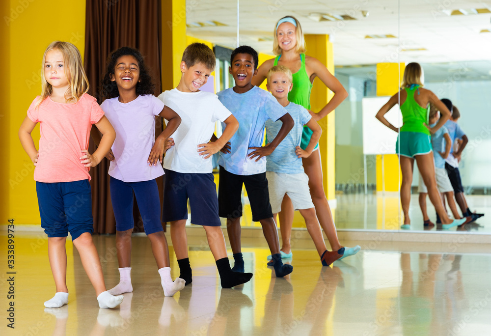 Children dancing choreography with female coach
