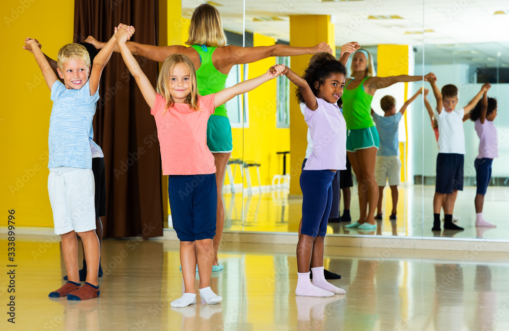 Children with teacher dancing in circle