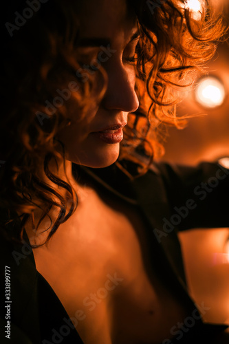 Silhouette of a woman's face . Against the background of bright lamps..