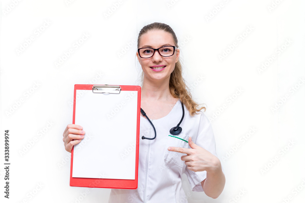 The female doctor happily shows her tablet with paper and smiles. Copy space. Mock up on a white isolated background. Positive information for patients about medicine. The good news, a warm welcome. The female doctor happily shows her tablet with paper and smiles. Copy space. Mock up on a white isolated background. Positive information for patients about medicine. The good news, a warm welcome.