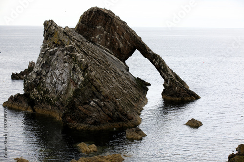 Portknockie (Scotland), UK - August 01, 2018: Bow Fiddle Rock sea arch, Portknockie, Scotland, Highlands, United Kingdom