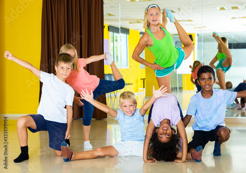 Fototapeta Naklejka Na Ścianę i Meble -  Positive children in dance studio smiling and having fun