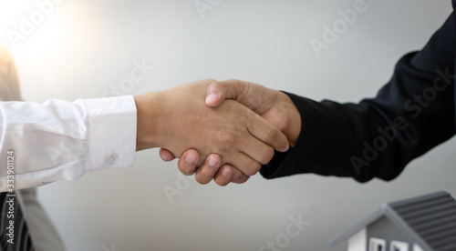 The property manager Shake hands with congratulations on the customers who bought the house with insurance, Hand shake, Success and congratulations concept.