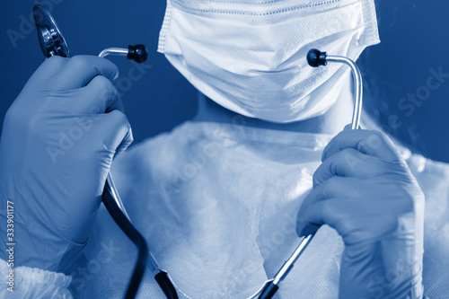 Nurse with phonendoscope, mask and cap.