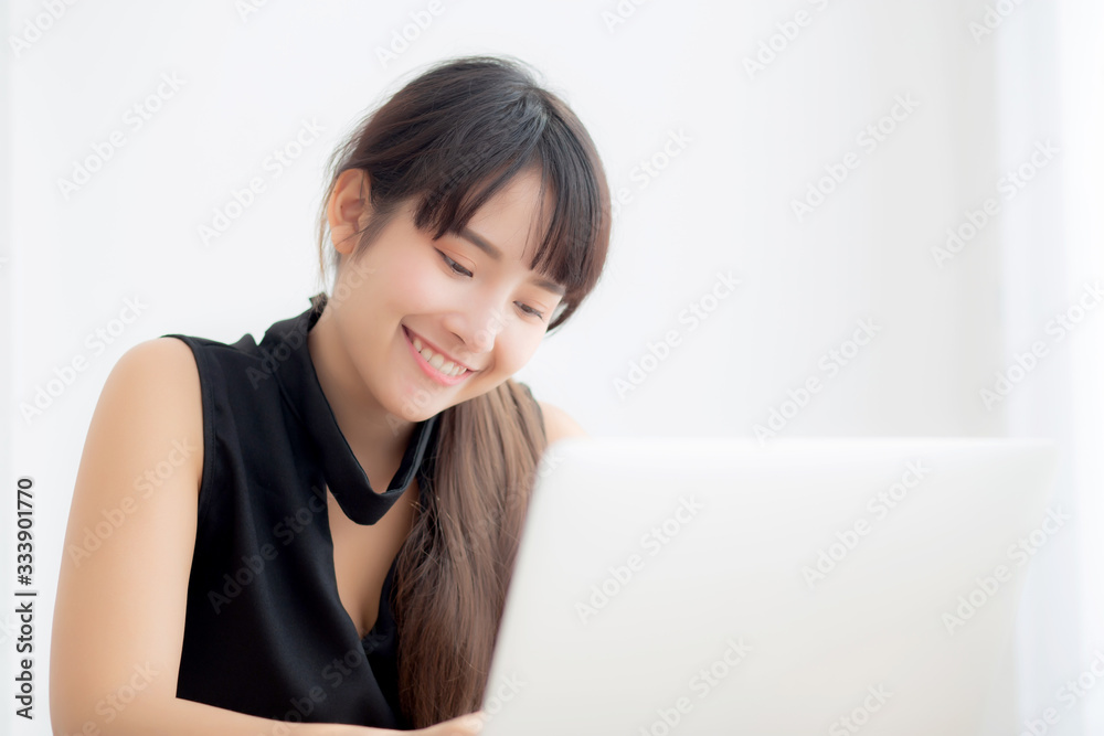 Beautiful freelance asian woman smiling working and typing on laptop computer at desk office with professional, girl using notebook checking email or social network, business and lifestyle concept. Beautiful freelance asian woman smiling working and typing on laptop computer at desk office with professional, girl using notebook checking email or social network, business and lifestyle concept.