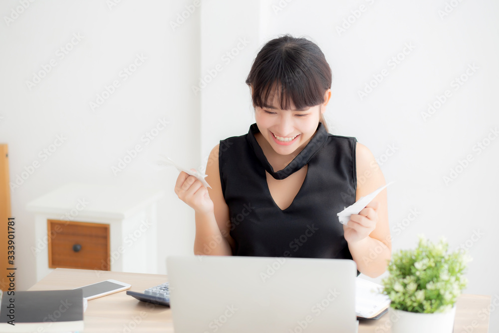 Beautiful young asian woman calculating finance household and writing notebook on desk, girl checking bill and success for saving expenses household with target, debt closure, business concept. Beautiful young asian woman calculating finance household and writing notebook on desk, girl checking bill and success for saving expenses household with target, debt closure, business concept.