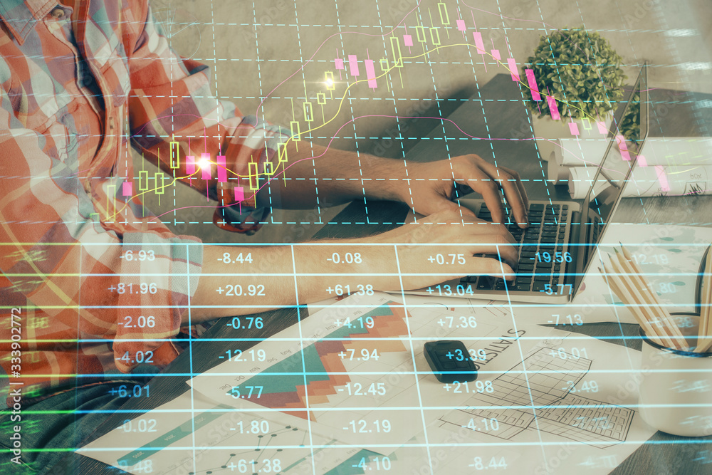 Double exposure of stock graph with businessman typing on computer in office on background. Concept of hard work. Double exposure of stock graph with businessman typing on computer in office on background. Concept of hard work.
