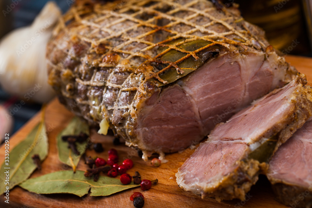 Appetizing pork ham with spices on a cutting board
