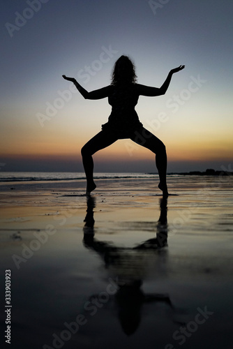 yoga at the sunset on the beach
