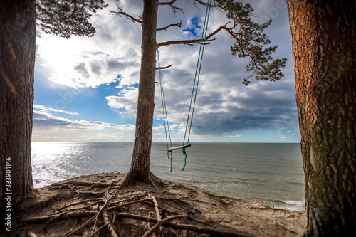 A Swing near a sea in a natural scene under strong highlight photo