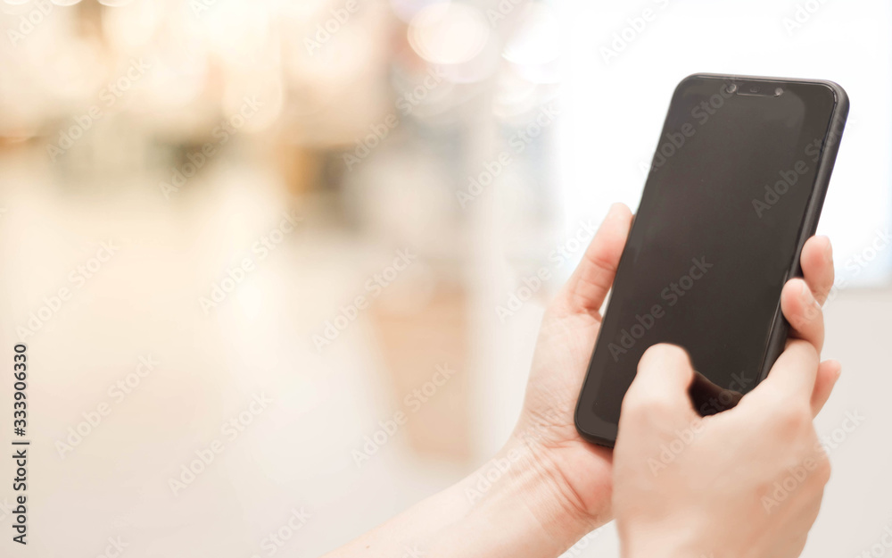 Woman hands holding smart phone with blank blank screen for text message or information content,