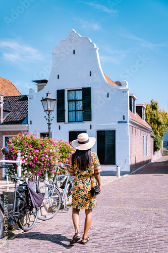 young couple on vacation Friesland Netherlands Sloten, old town of Sloten Netherlands with canals and windmill photo