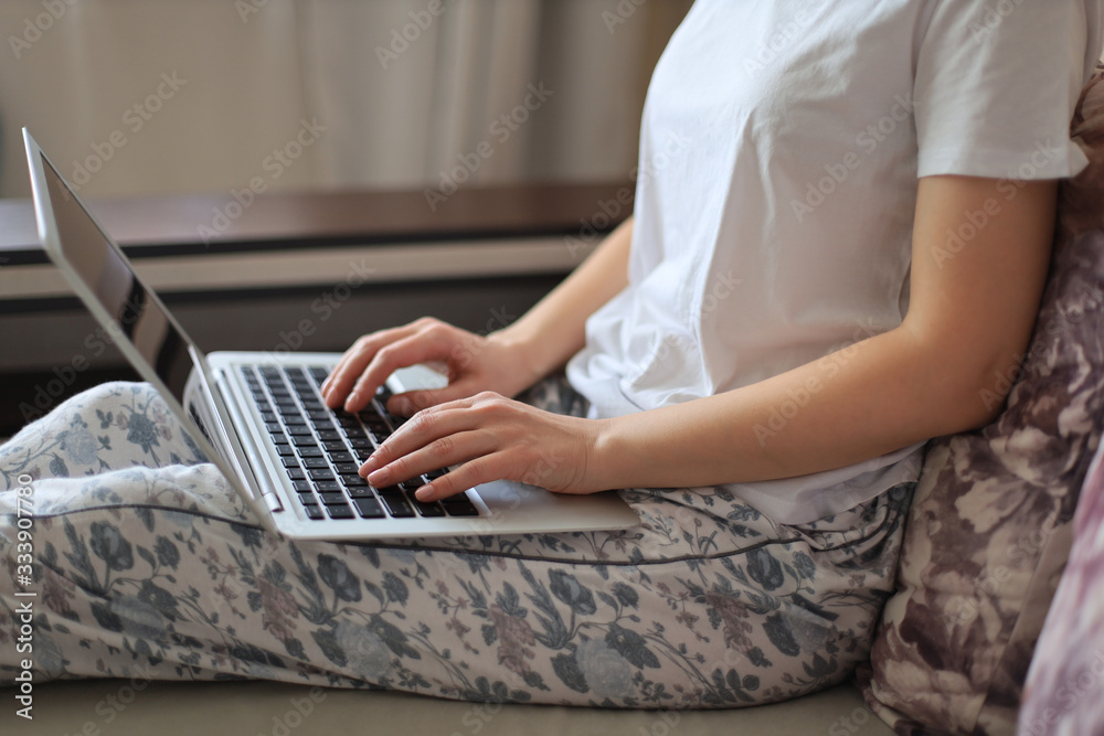 Naklejka premium Young woman works from home during self isolation and quarantine. Work online and stay at home.