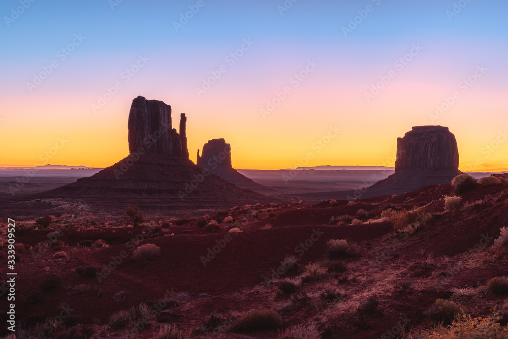 Beautiful colorful sunrise view of famous Buttes of Monument Valley on the border between Arizona and Utah, USA