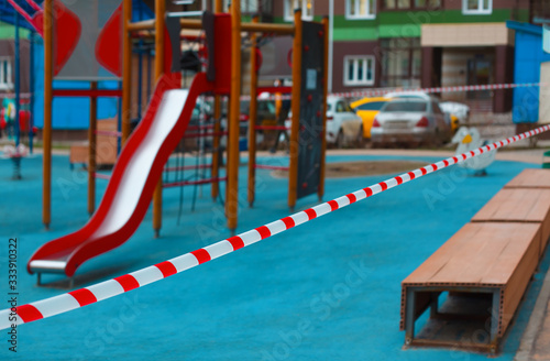 Children's playground fenced with tape. Restricted area during coronavirus or covid 19 virus.