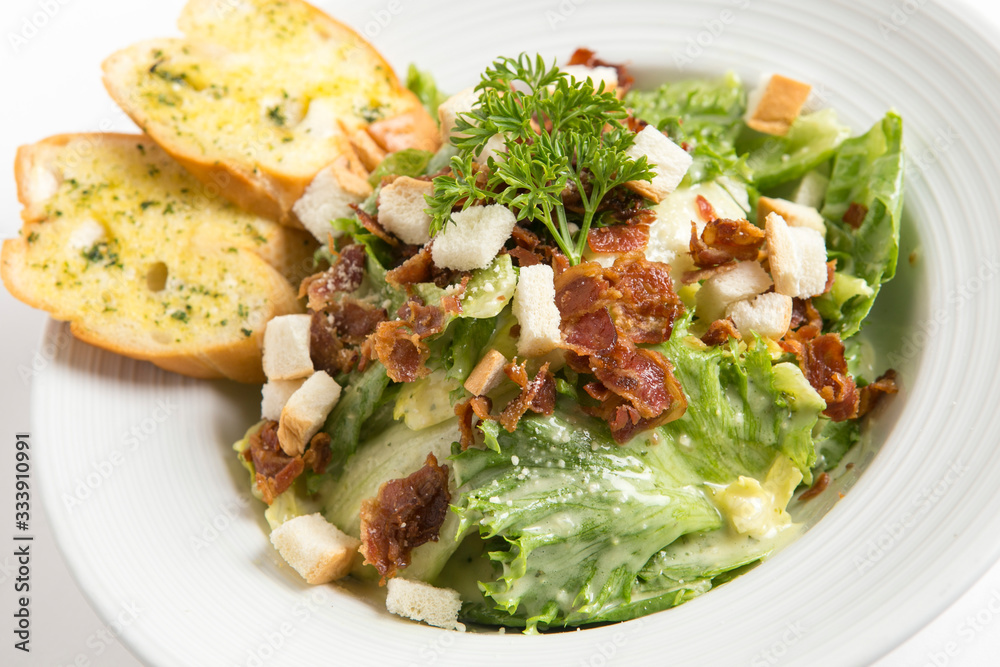 caesar salad serve with garlic bread serve in white plate close up shot caesar salad serve with garlic bread serve in white plate close up shot