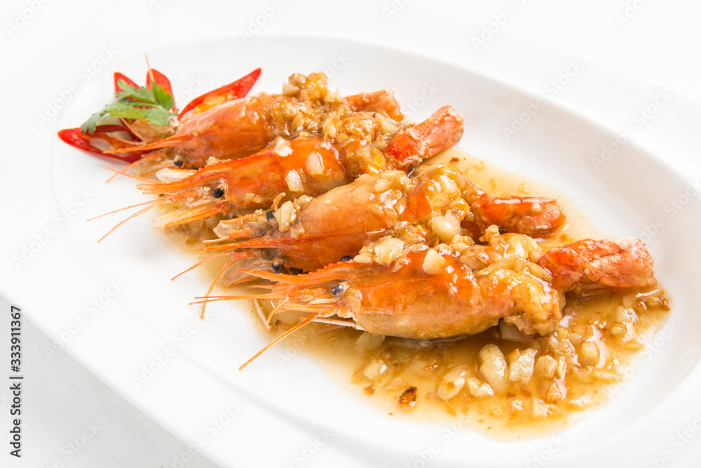 fired giant freshwater prawn with garlic sauce serve in white plate closeup shot fired giant freshwater prawn with garlic sauce serve in white plate closeup shot