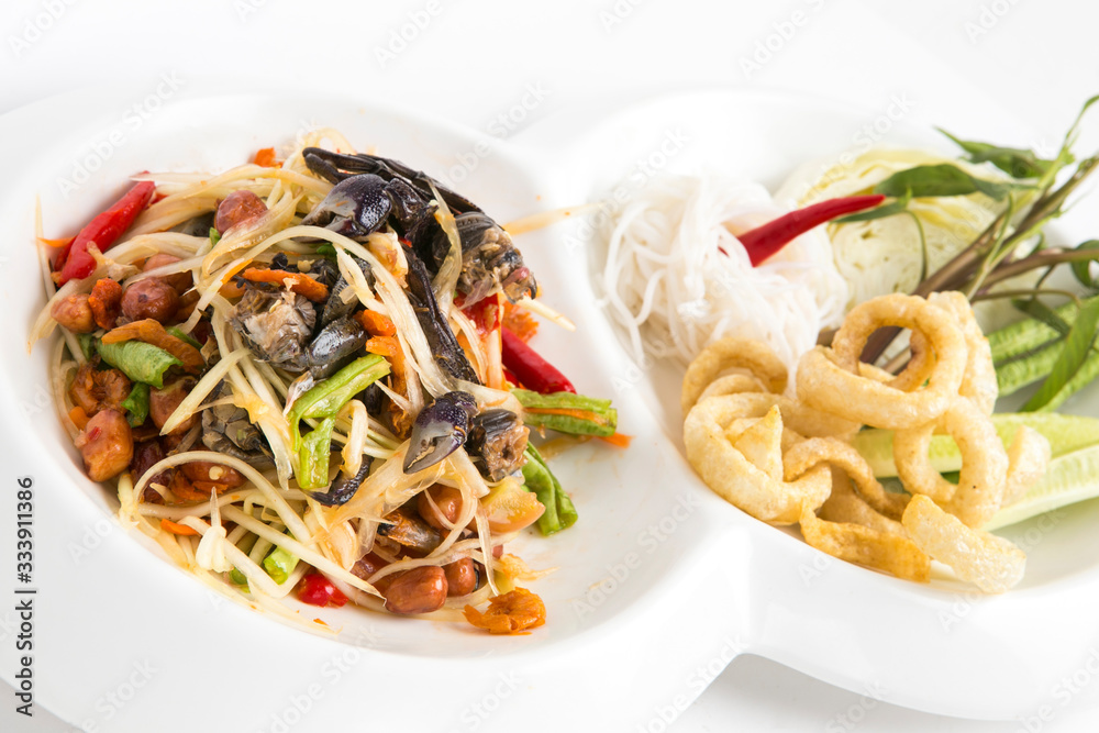 spicy papaya salad with small crabs eat with thai noodle and fired skin pork