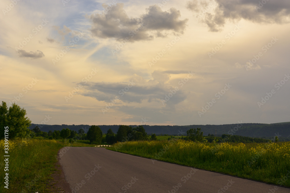 Road outside the city at sunset