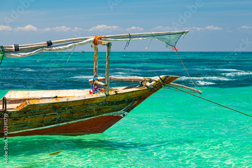 Colorful african wooden boat in ocean