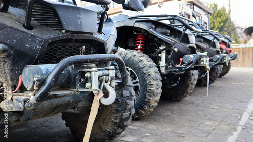 Photography Many parked ATVs on a dirt road, close up