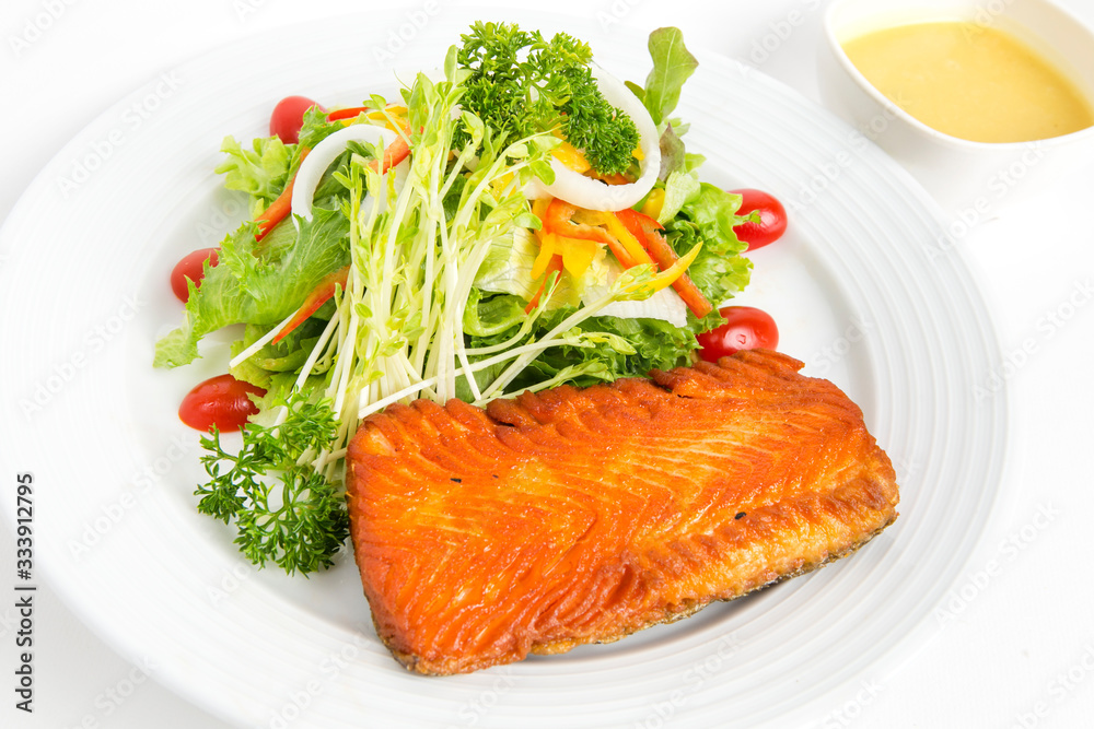 grilled salmon salad serve with mixed clear noodle coriander decorate by parsley and chili serve in white plate isolated white background grilled salmon salad serve with mixed clear noodle coriander decorate by parsley and chili serve in white plate isolated white background